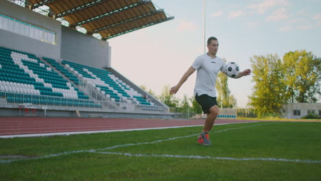 A-soccer-player-in-gear-on-a-soccer-field-near-the-stands-receives-a-pass-and-runs-away-with-a-soccer-ball-in-slow-motion